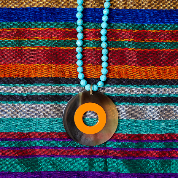 turquoise howlite necklace w orange lacquer and horn pendant