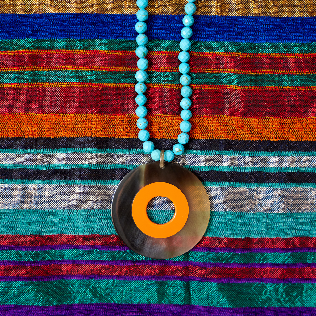 turquoise howlite necklace w orange lacquer and horn pendant